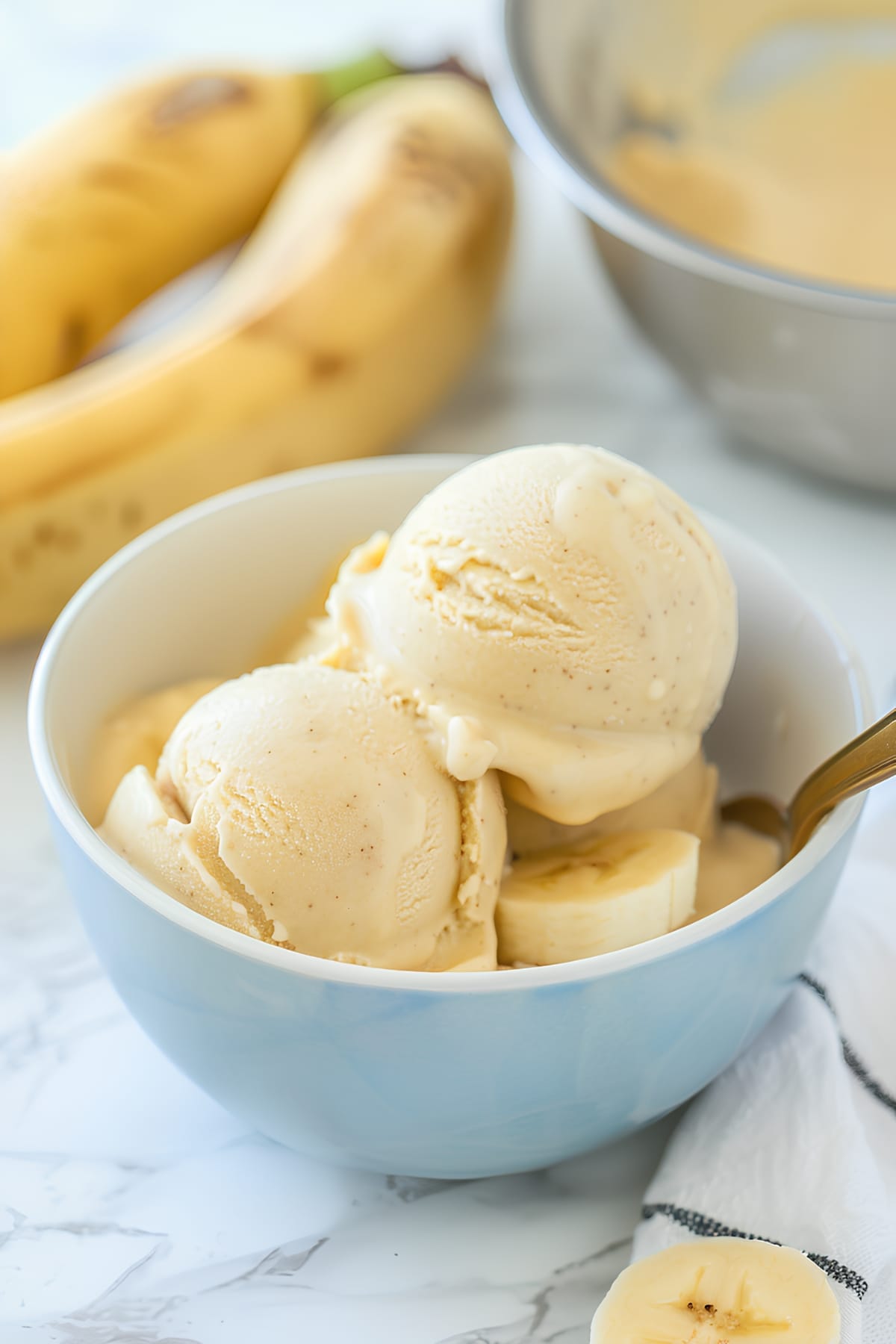 Homemade cold and creamy banana ice cream in a blue bowl