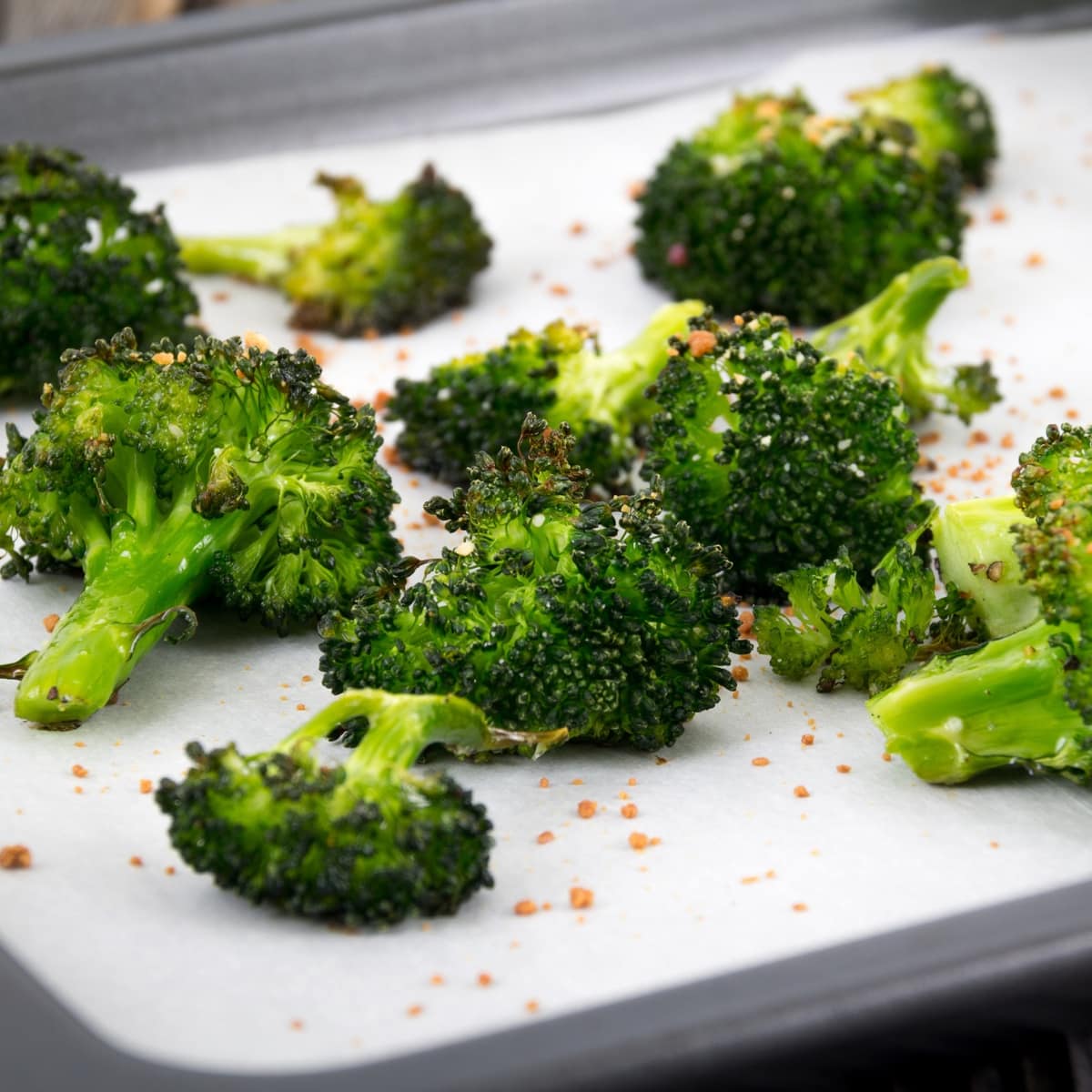 Broccoli florets in a baking sheet.
