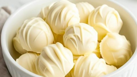 Bunch of white chocolate truffles on a bowl.