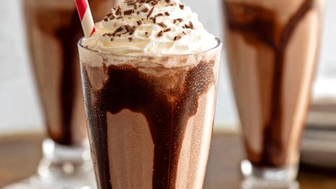 Chocolate milkshake with whipped cream and chocolate shavings, close-up