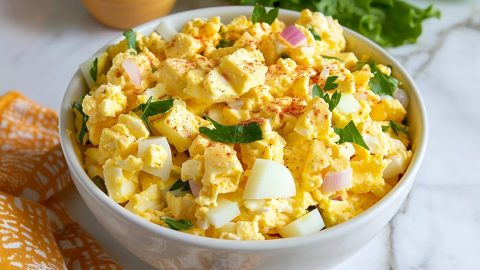 Simple and classic homemade egg salad sandwich in a white bowl