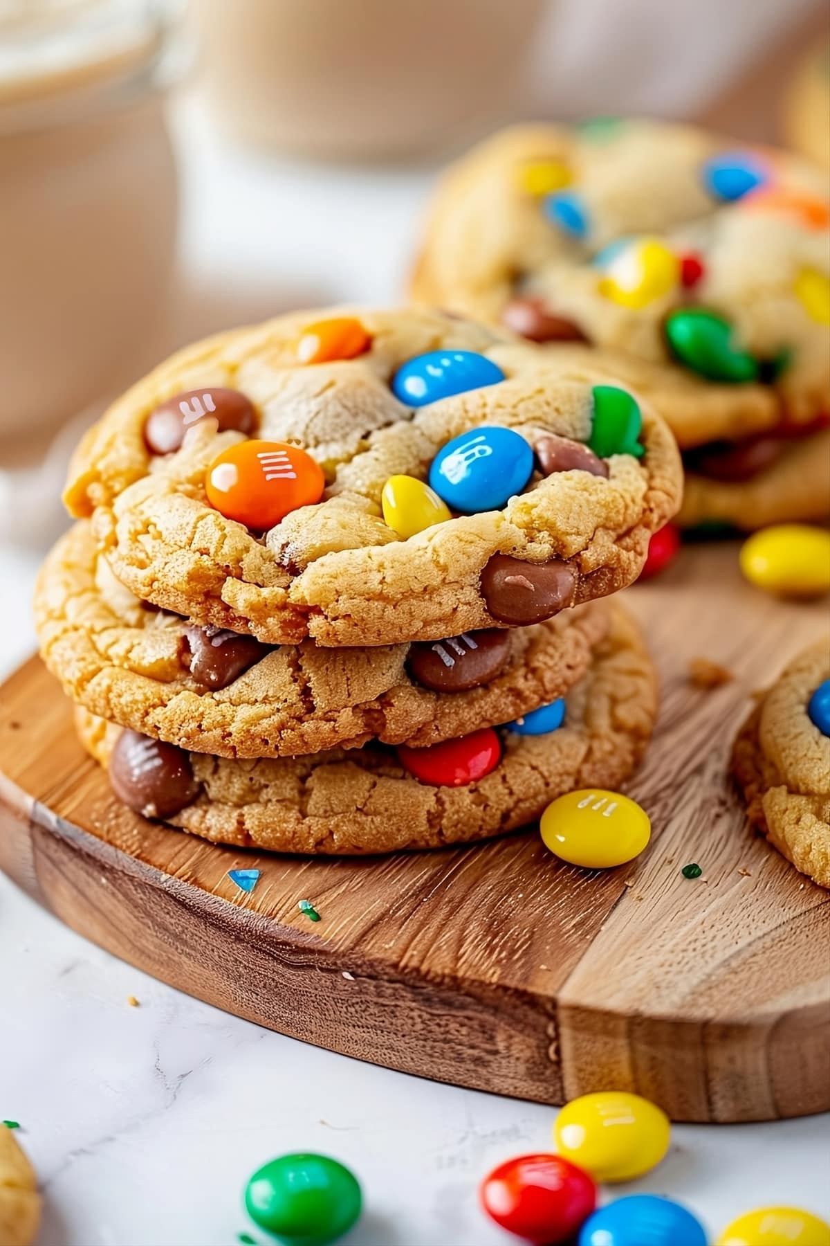 Stacked M&Ms cookies in a wooden board.