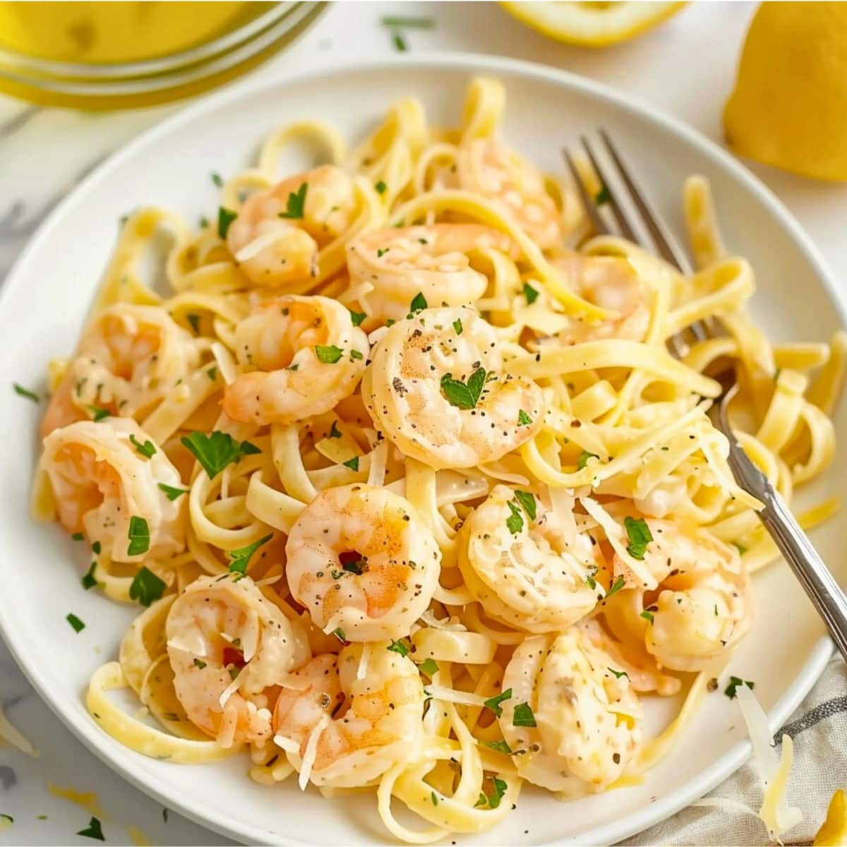 Lemon shrimp pasta served on a white plate.