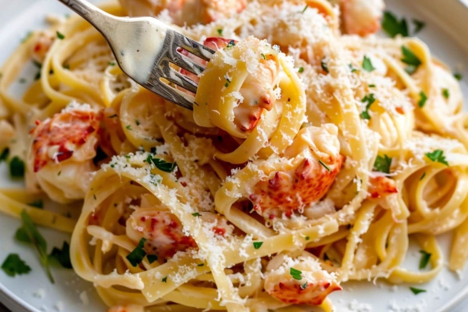 Fork picking from a serving of creamy and cheesy lobster pasta in a plate.