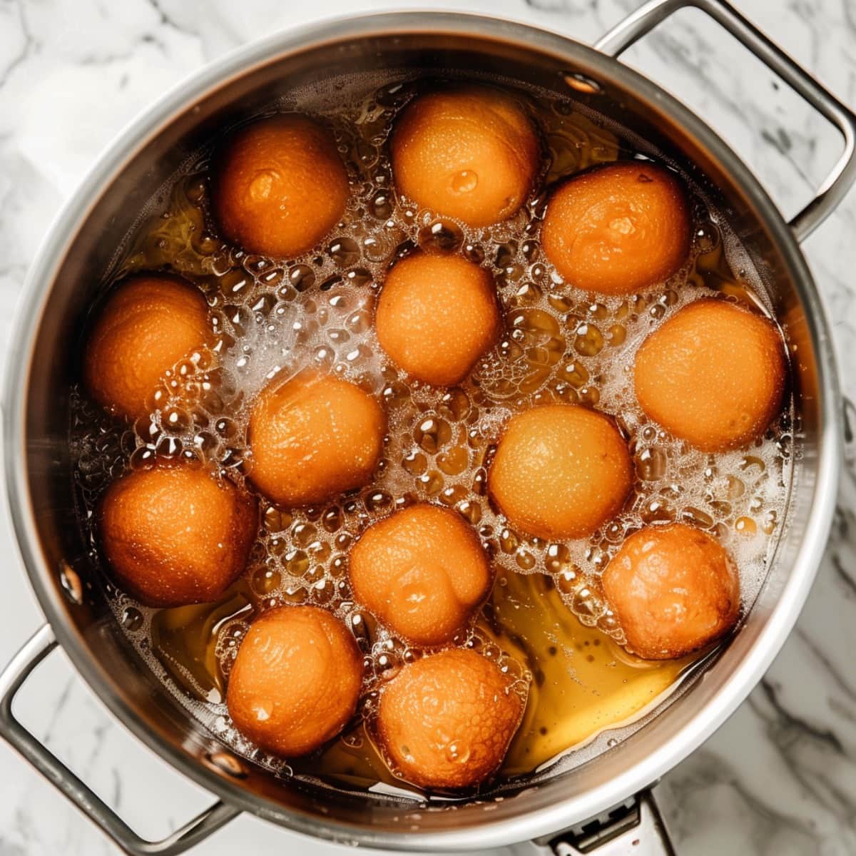 Donut Holes frying in a pot