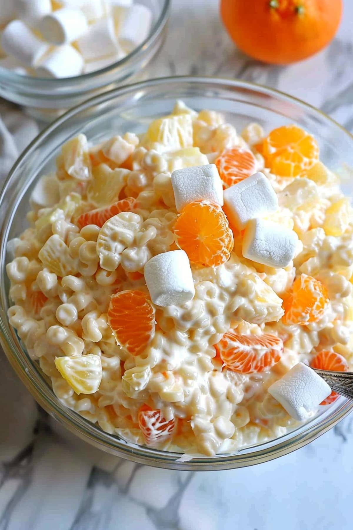 Cold fruit frog eye salad with oranges, pineapple and mini marshmallows
