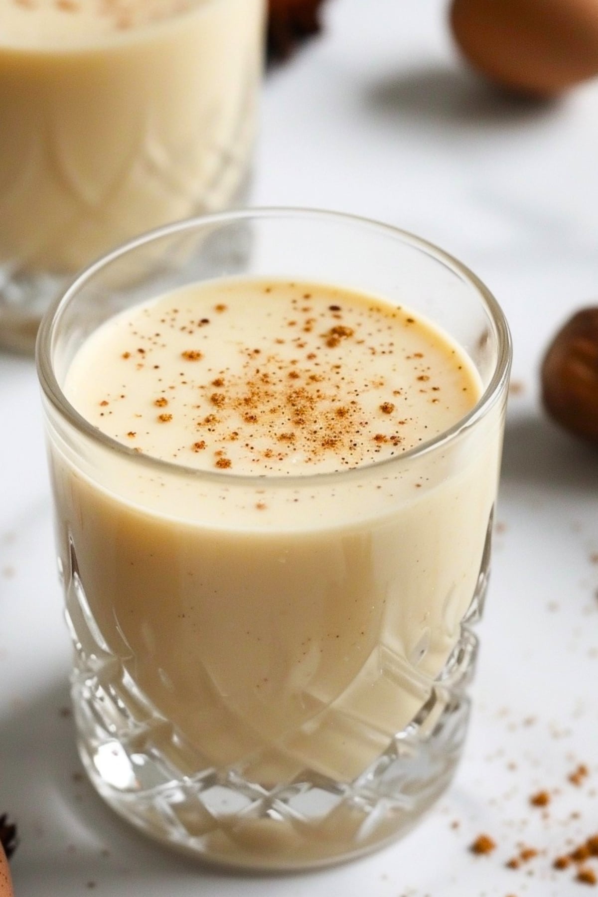 Glass of homemade eggnog with grated nutmeg