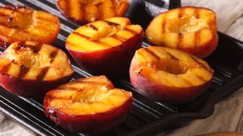 Peached cut in halves grilled on a grilling pan.