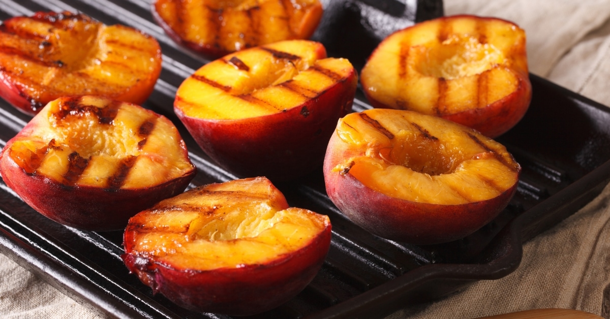 Peached cut in halves grilled on a grilling pan.