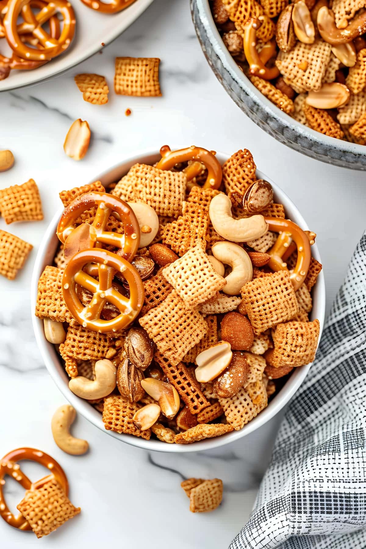 Bowl of Homemade Chex Mix with Mix Nuts and Salty Pretzels