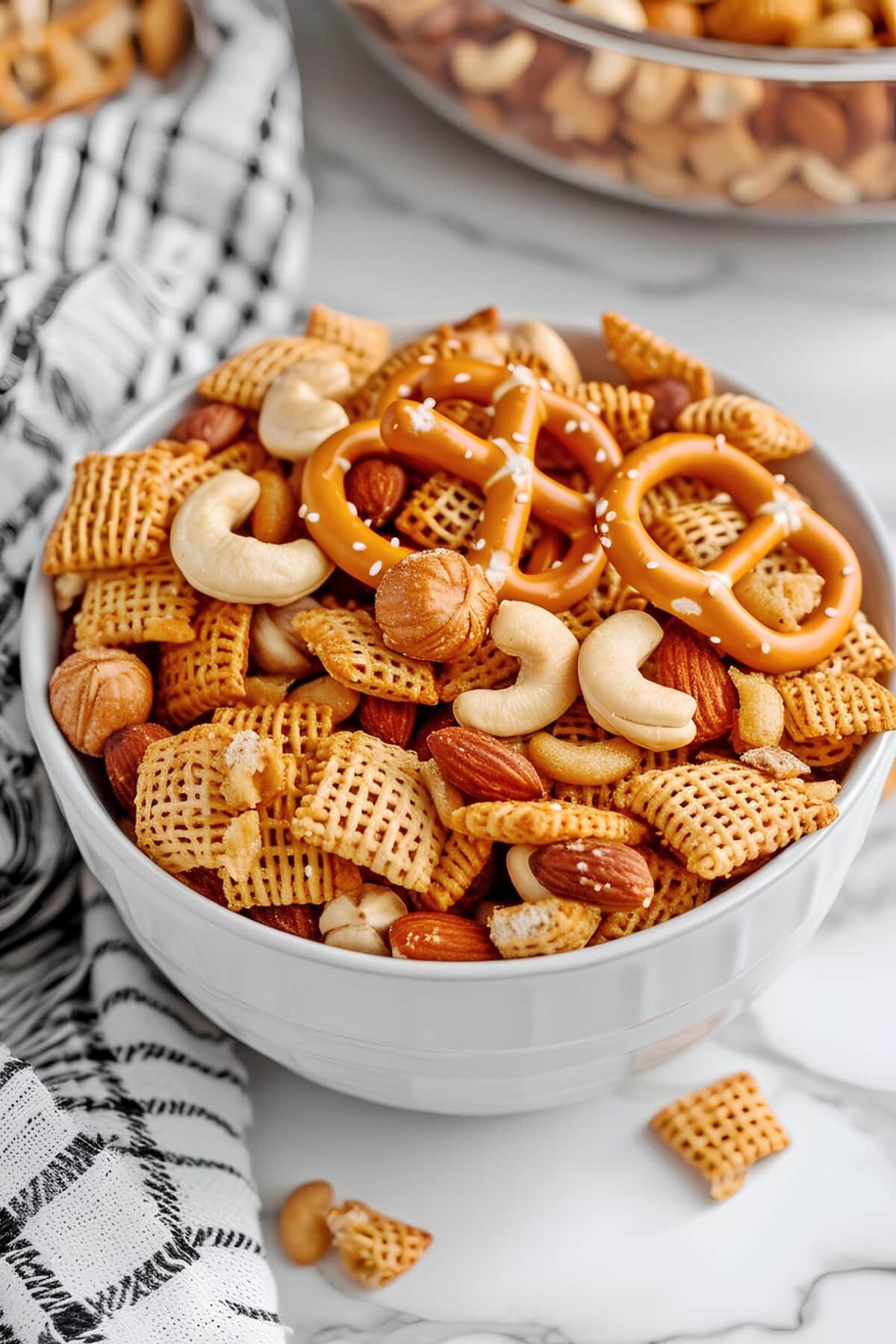 Crispy and crunchy chex mix in a bowl with nuts and pretzels 