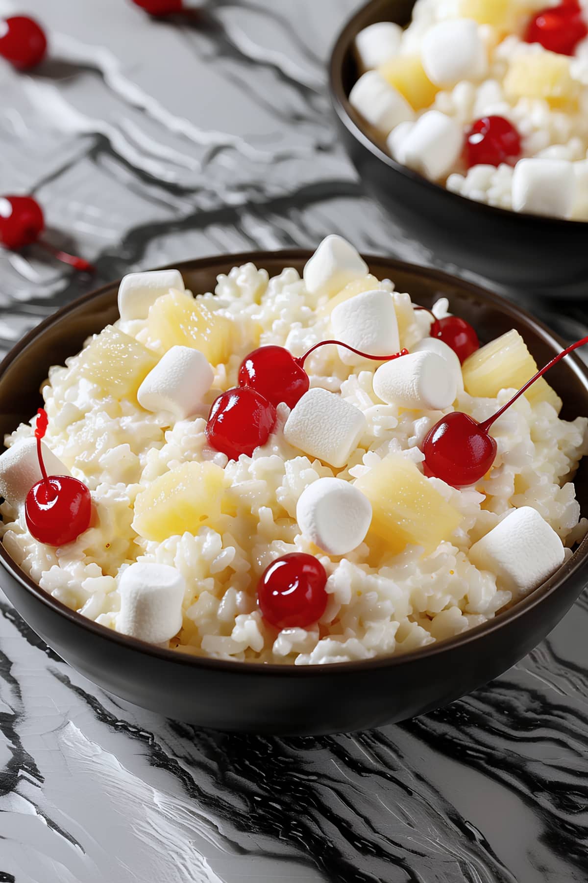 Homemade glorified rice topped with pineapple bits, maraschino cherries and marshmallows