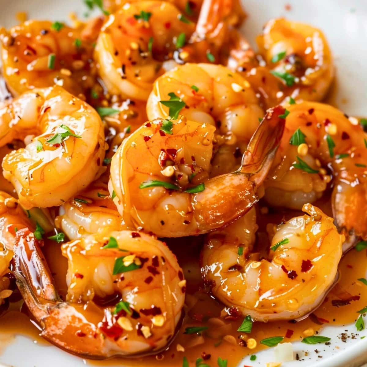 Shrimp in honey garlic sauce seasoned with pepper flakes.