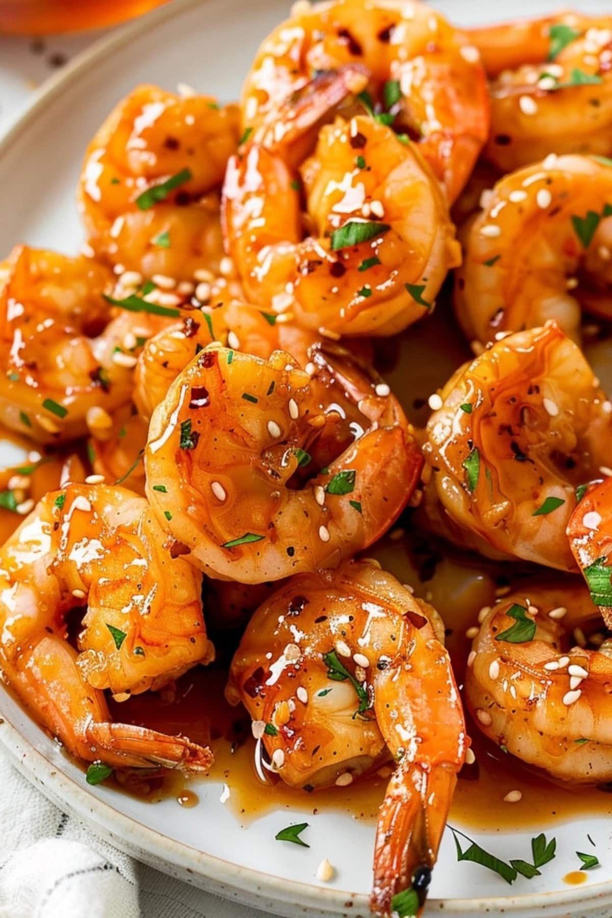Shrimp with honey garlic sauce served on a white plate.