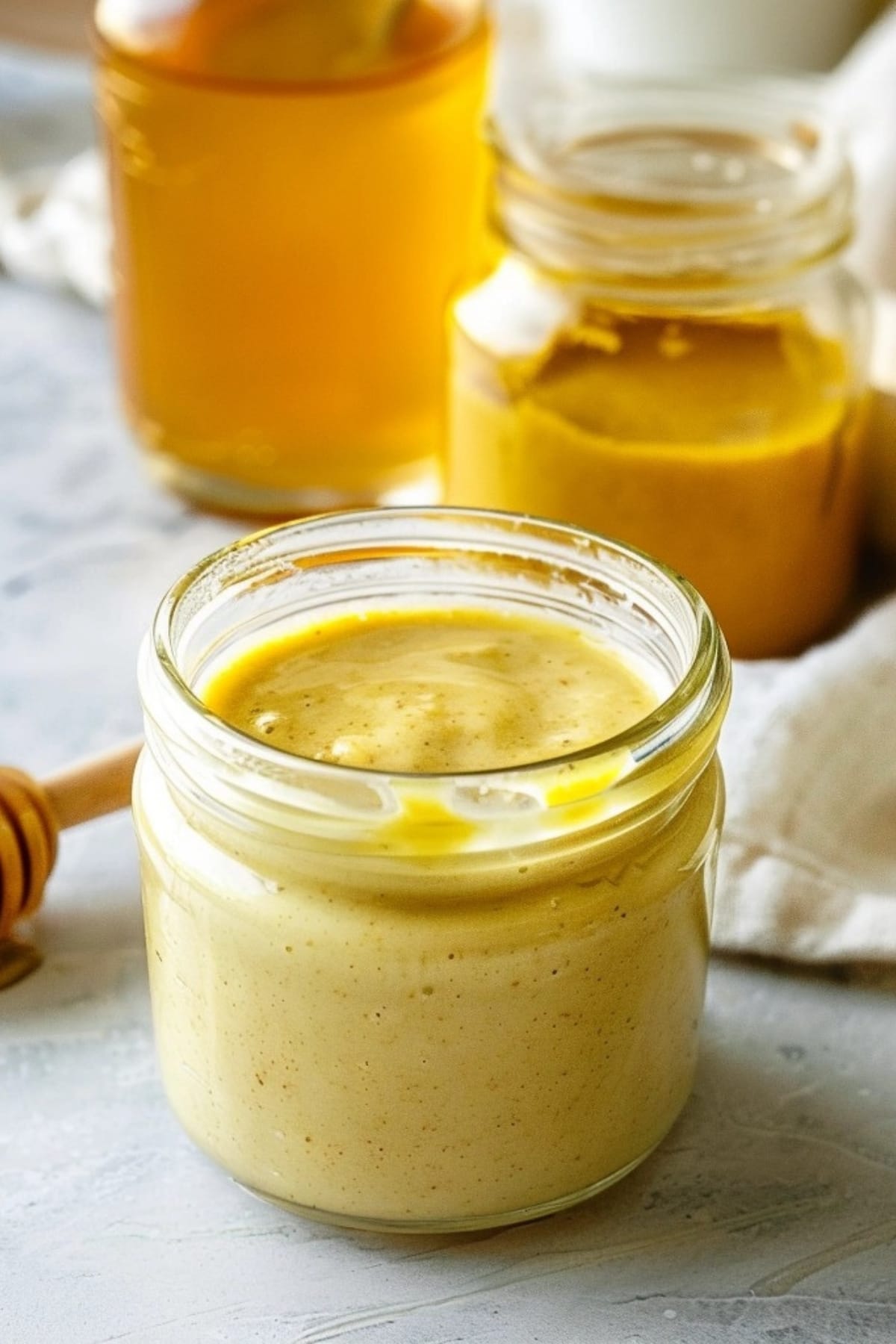 Honey mustard sauce in a small glass jar.