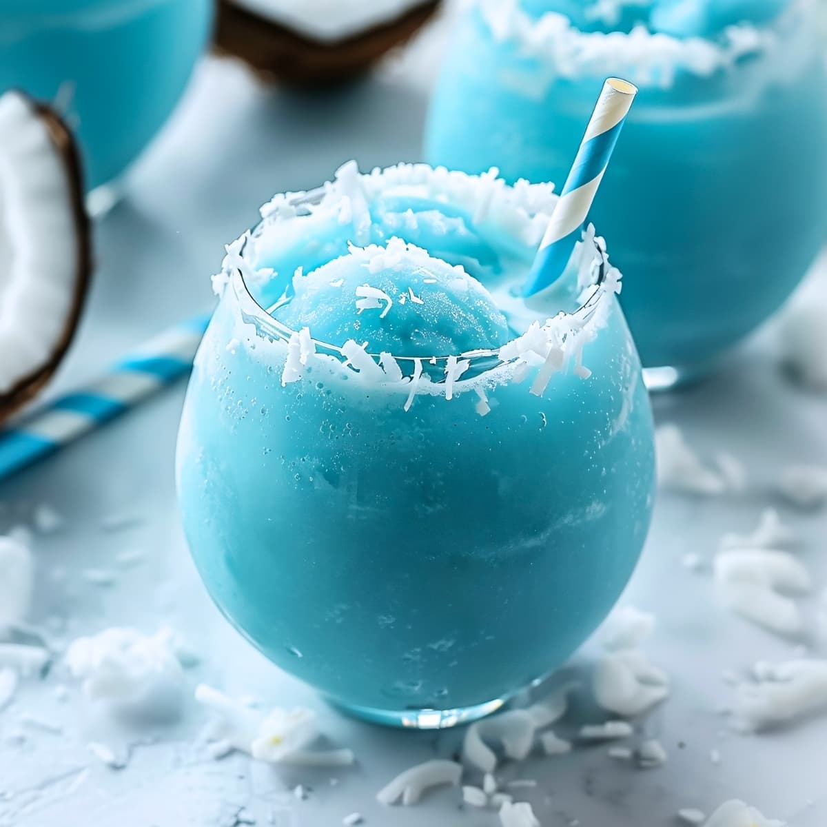 Homemade Jack Frost cocktail in a glass with a rim of shredded coconut