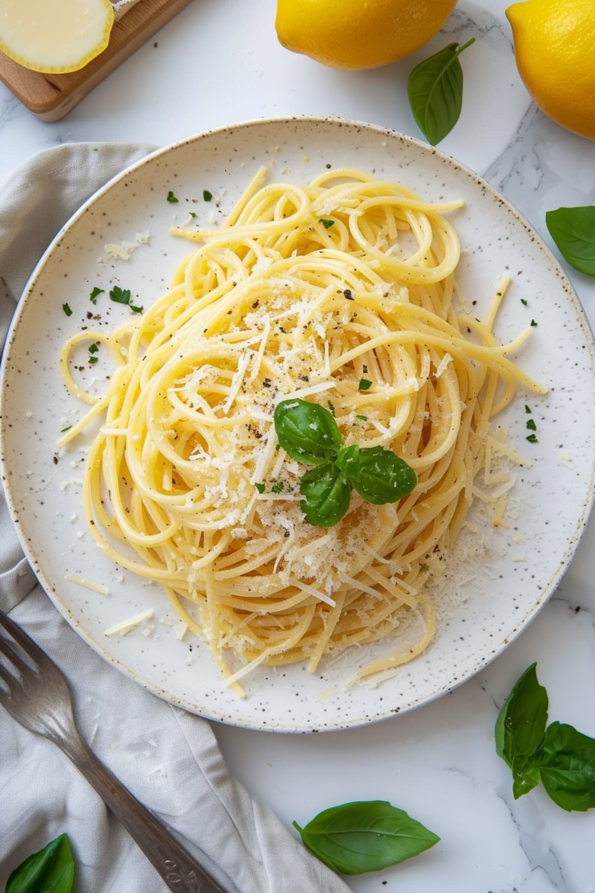 Lemon spaghetti with topped with basil and parmesan cheese