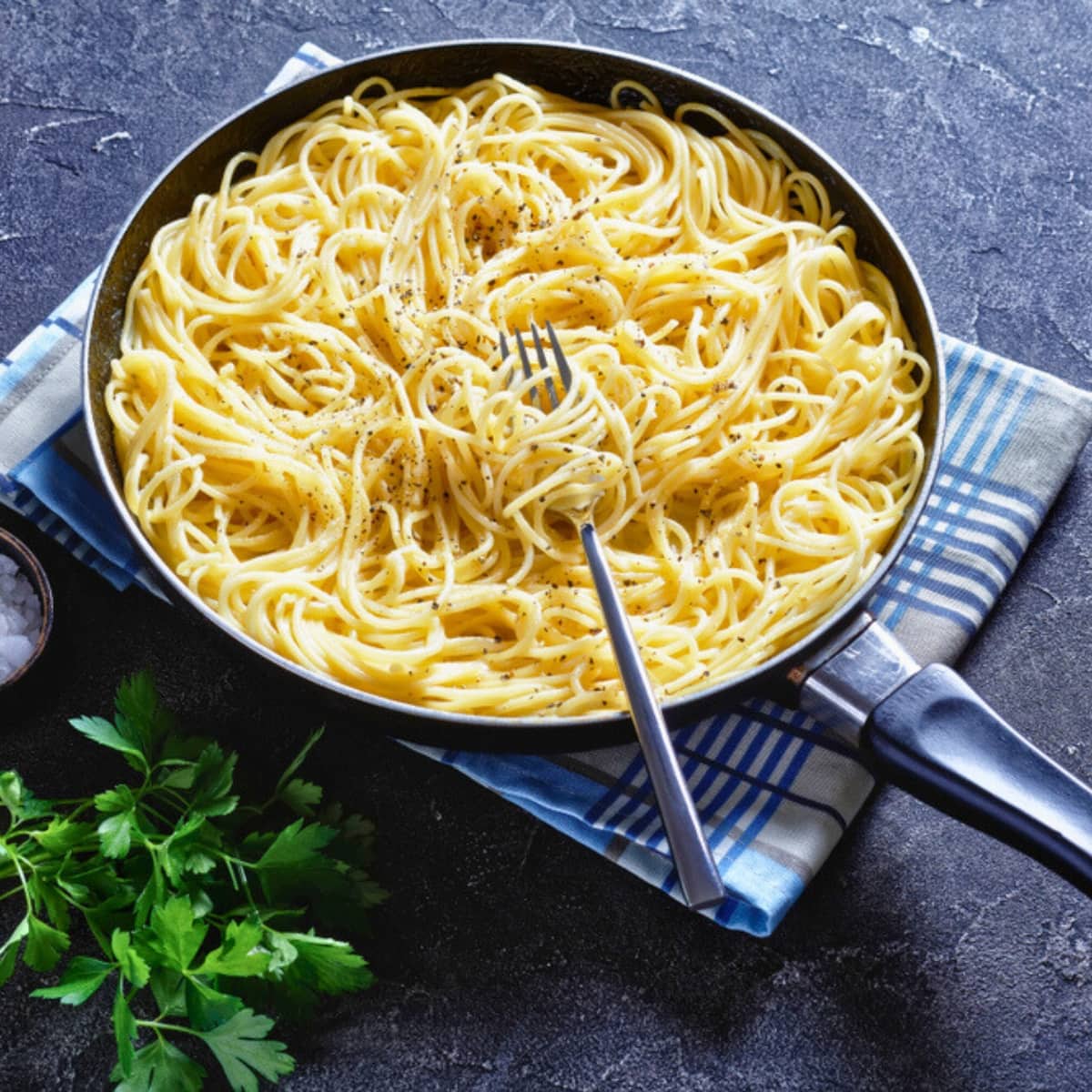 Cacio E Pepe pasta cooked in a pan with black pepper.