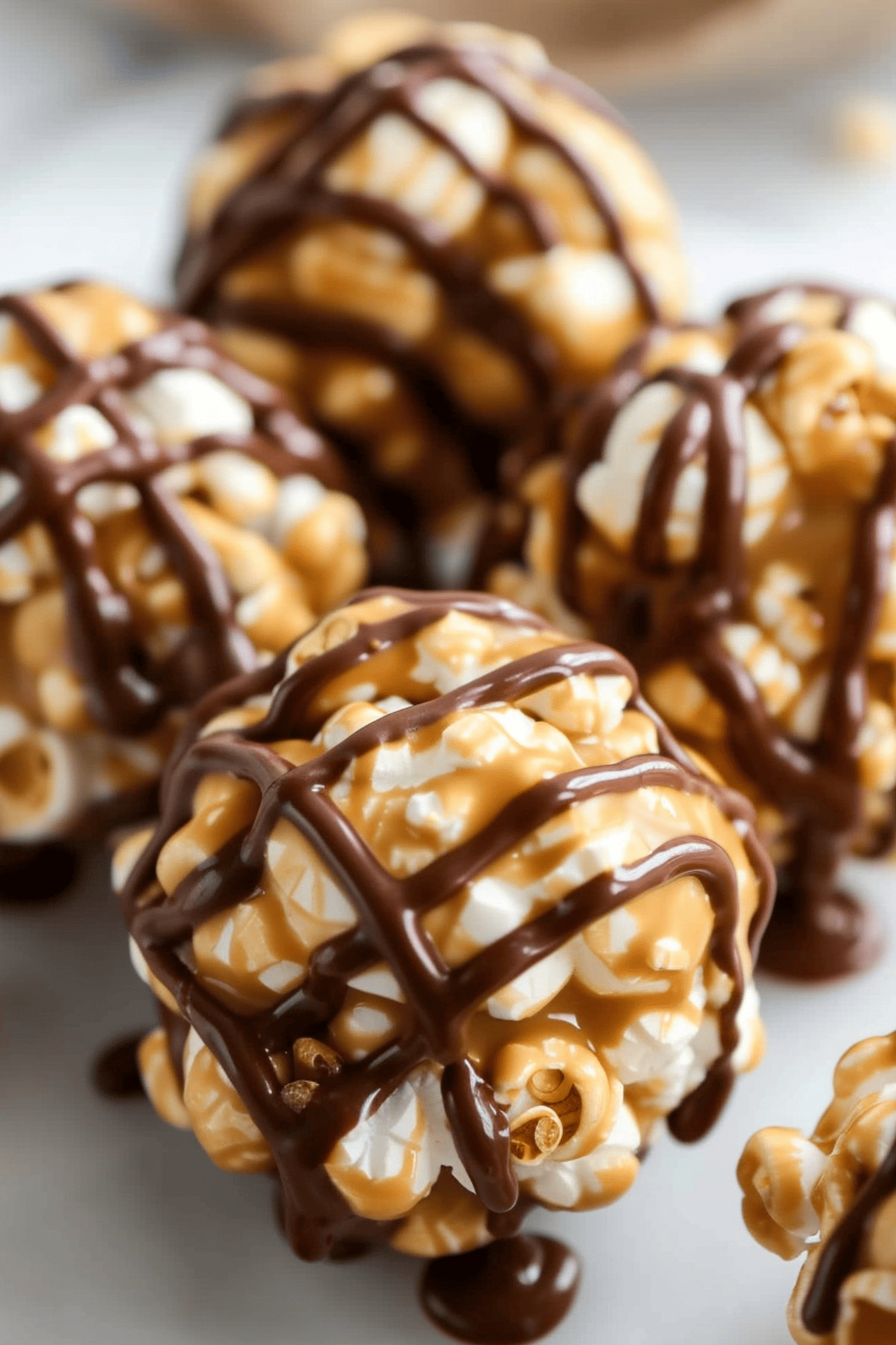 Close-Up shot of peanut butter popcorn balls with drizzled chocolate