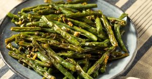Roasted green beans on a plate.