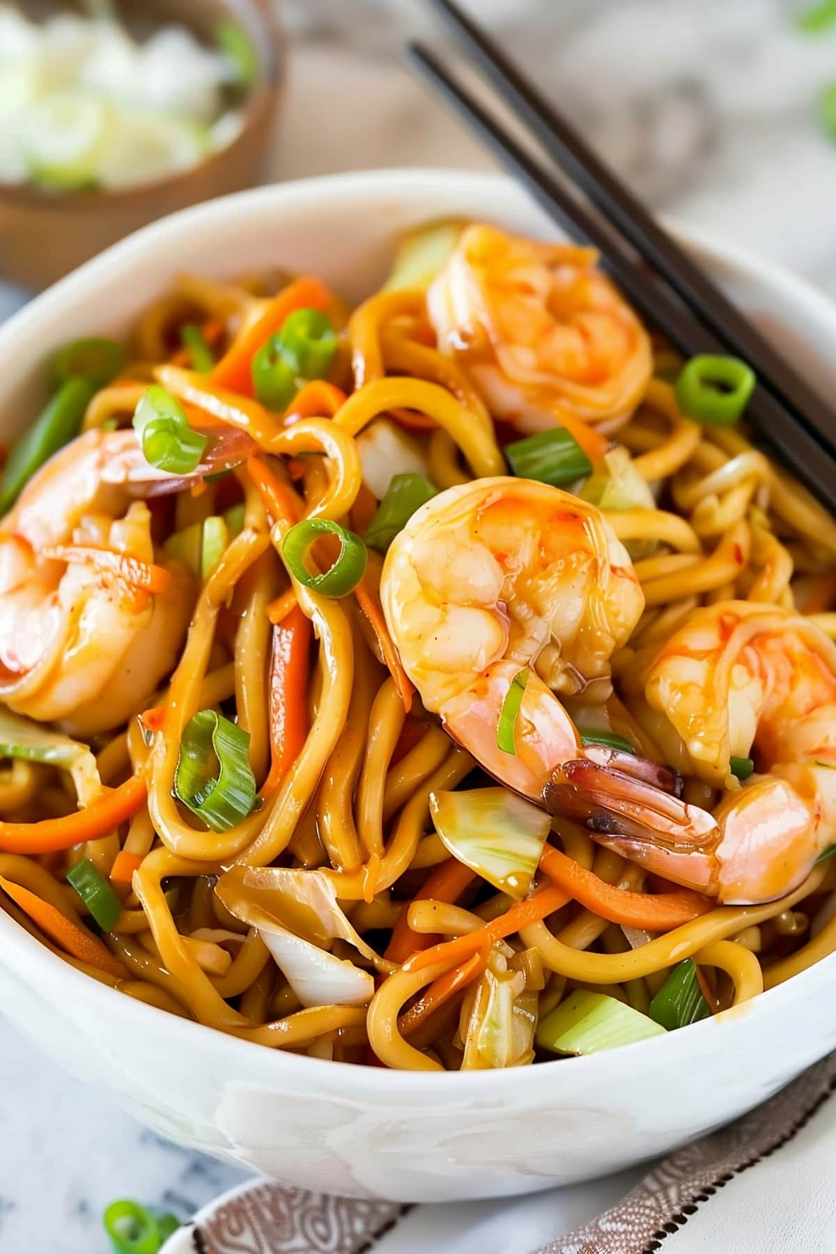 Shrimp lo mein noodles in a bowl with vegetables