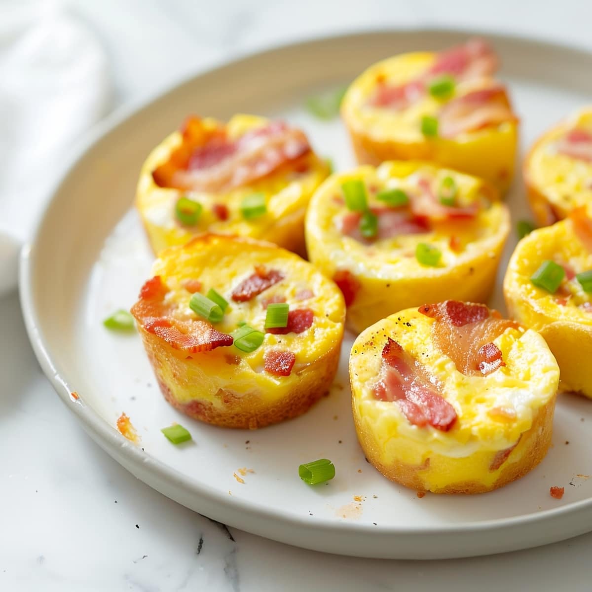 Homemade bacon and egg muffins topped with green onions