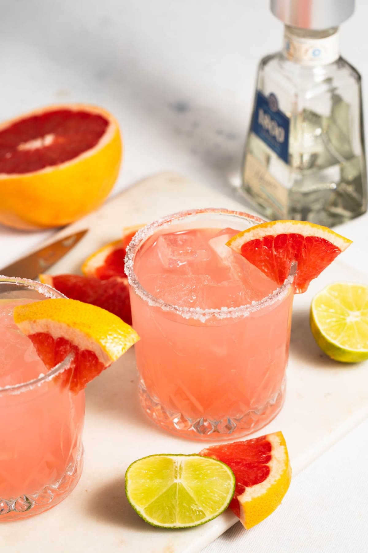 Paloma cocktails with grapefruit slices and lime in glasses