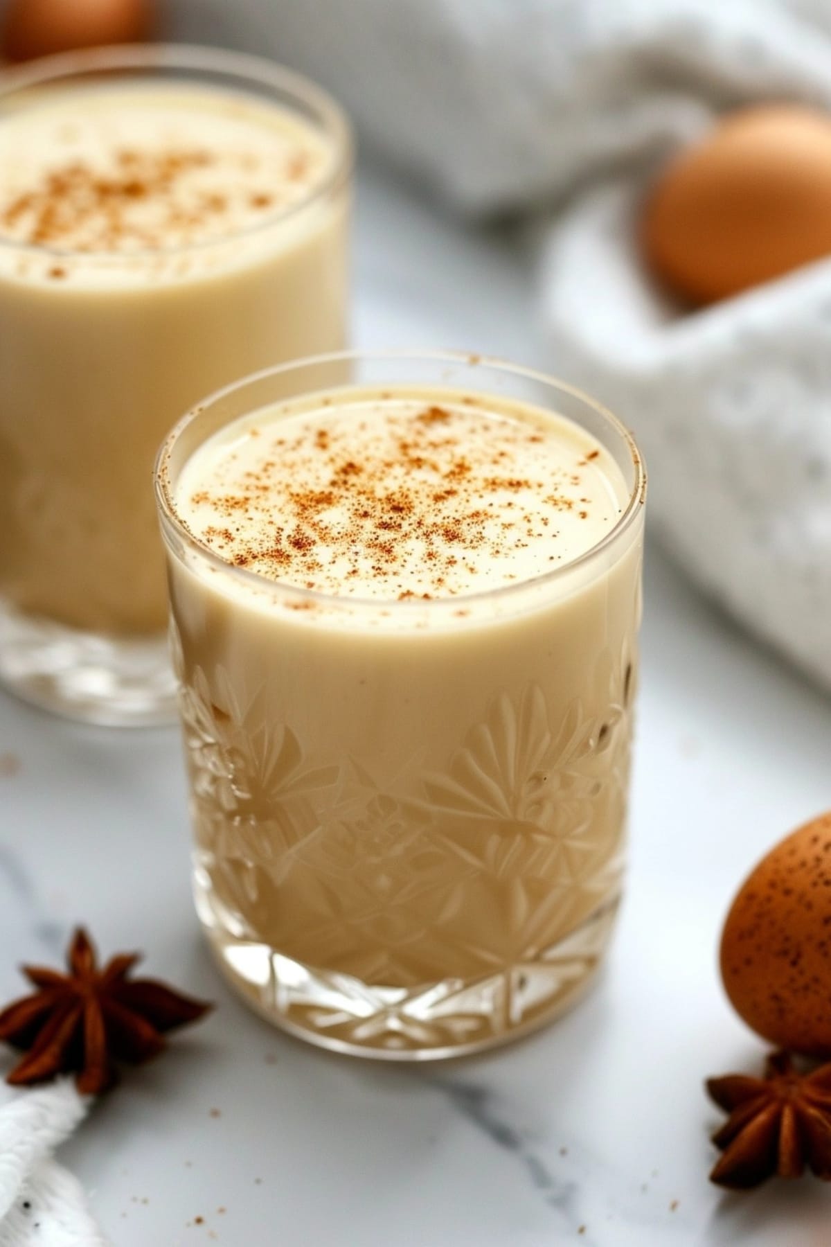 Two glasses of eggnog with nutmeg