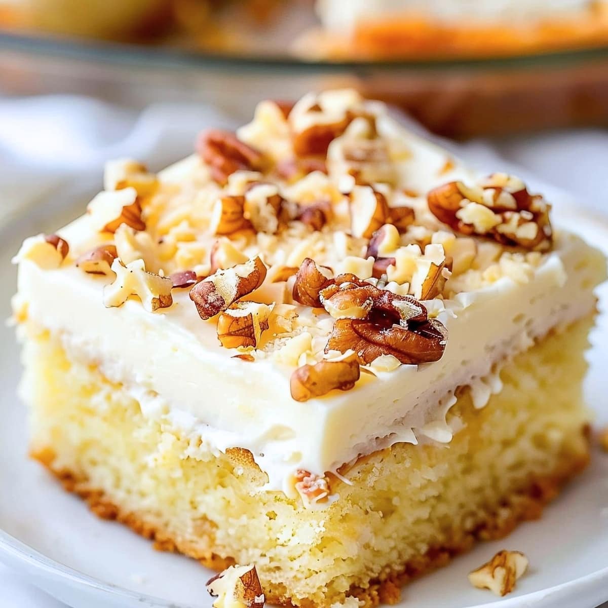 A slice of Elvis Presley yellow cake squares with cream cheese and pecan nuts