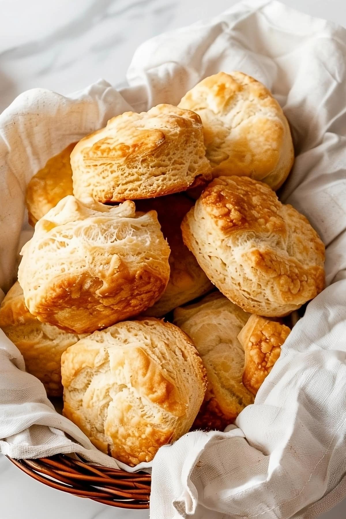 Bunch of air fried biscuits in a basket.
