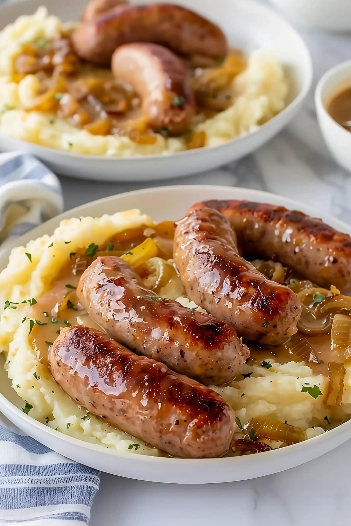 Mashed potatoes topped with sausage and onion gravy.
