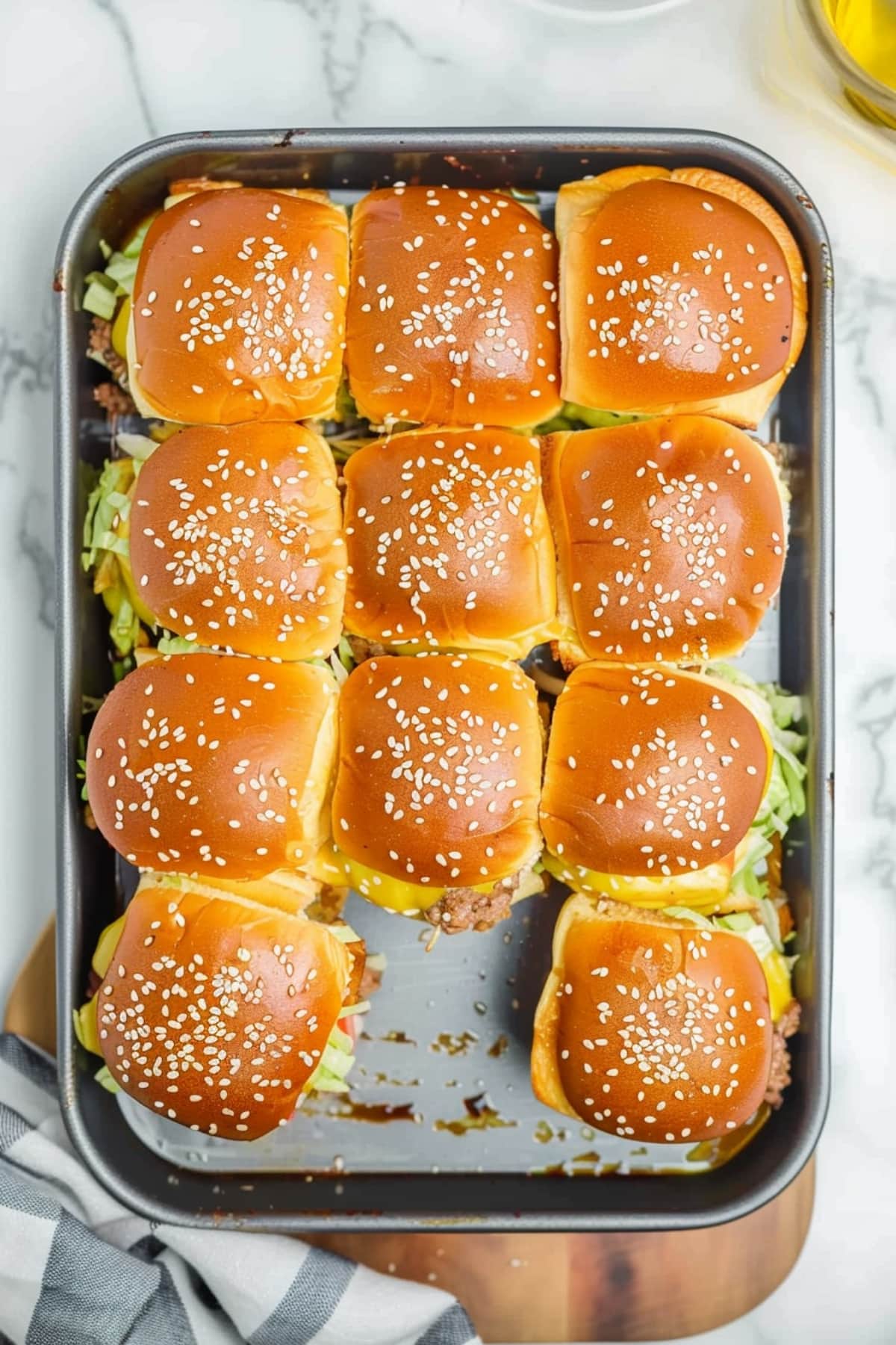 A tray of sesame seed-topped big mac sliders, ready to be savored