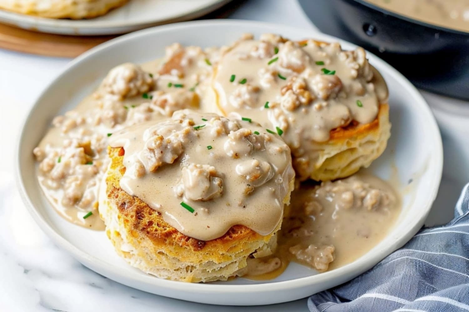 Biscuits and gravy in a white plate, a savory and comforting dish