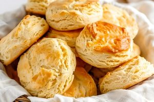 Air fried biscuits in a basket with cloth lining.