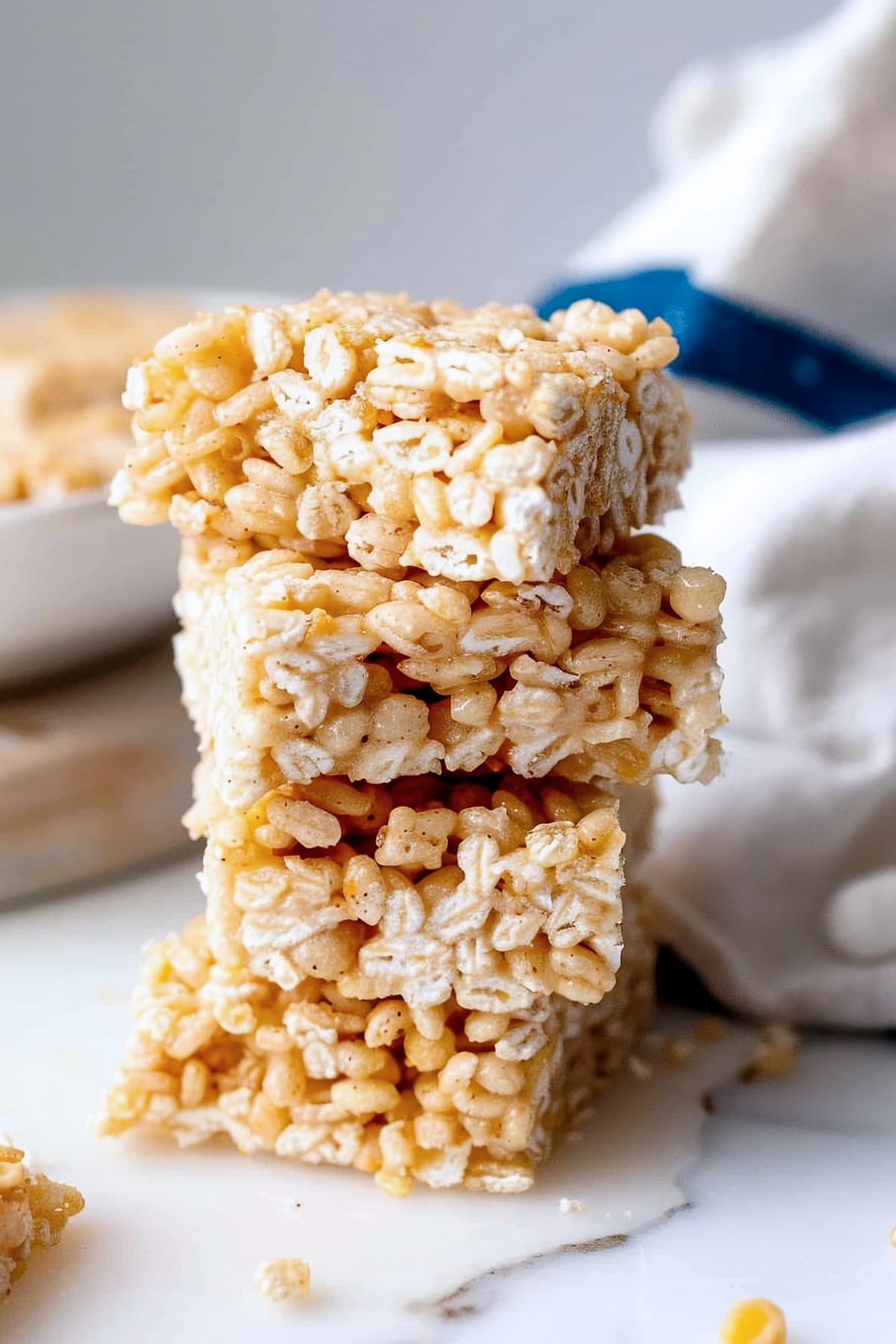 A stack of brown butter rice krispie treats on a white marble table
