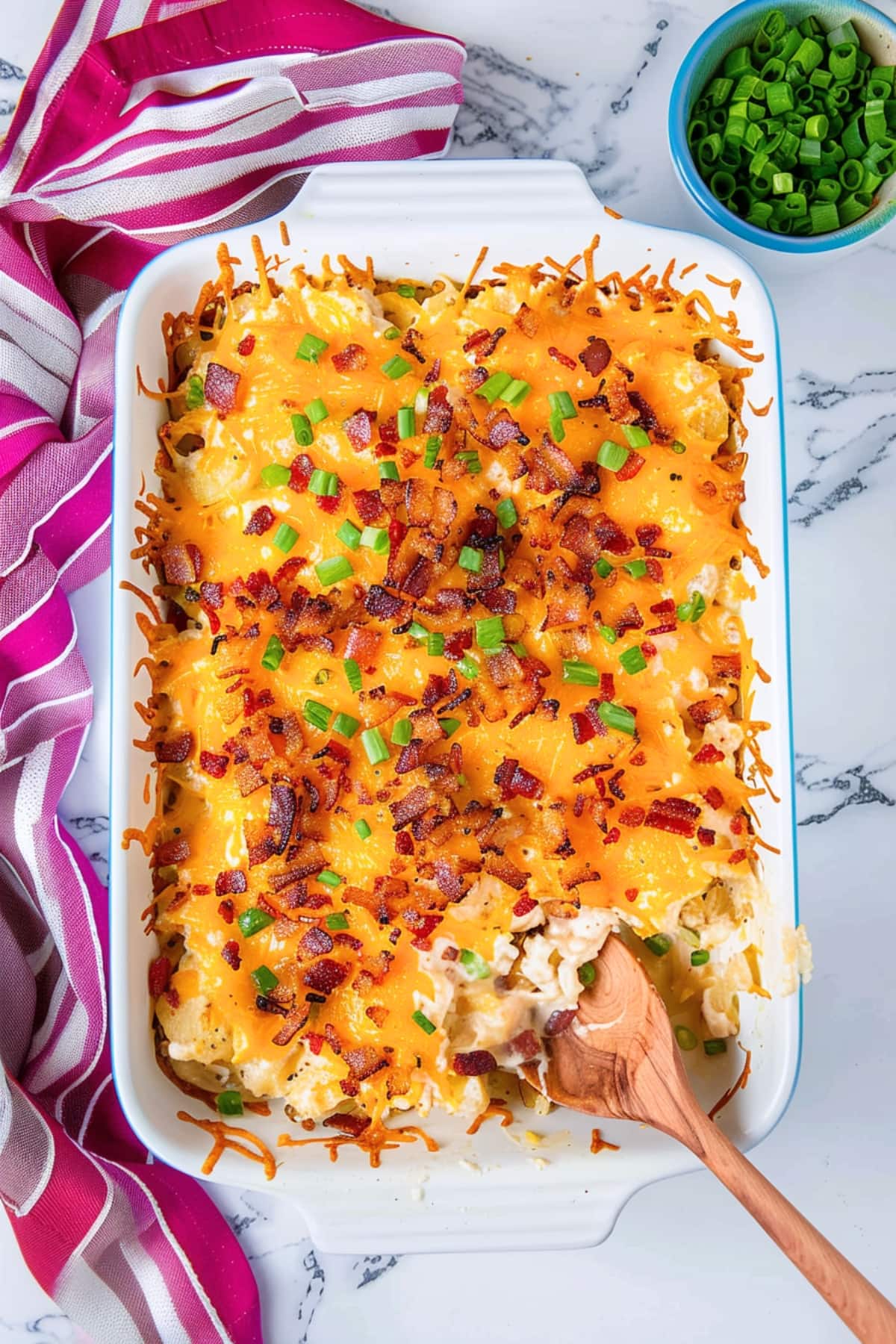 Crack potatoes with bacon and green onions in a 9x13 baking dish