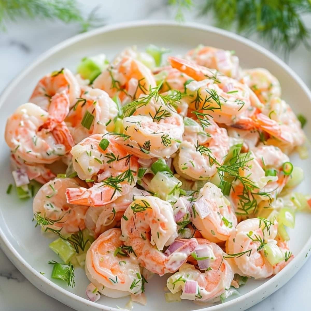 Creamy shrimp salad with mayonnaise dressing, dill, chopped celery and onion.