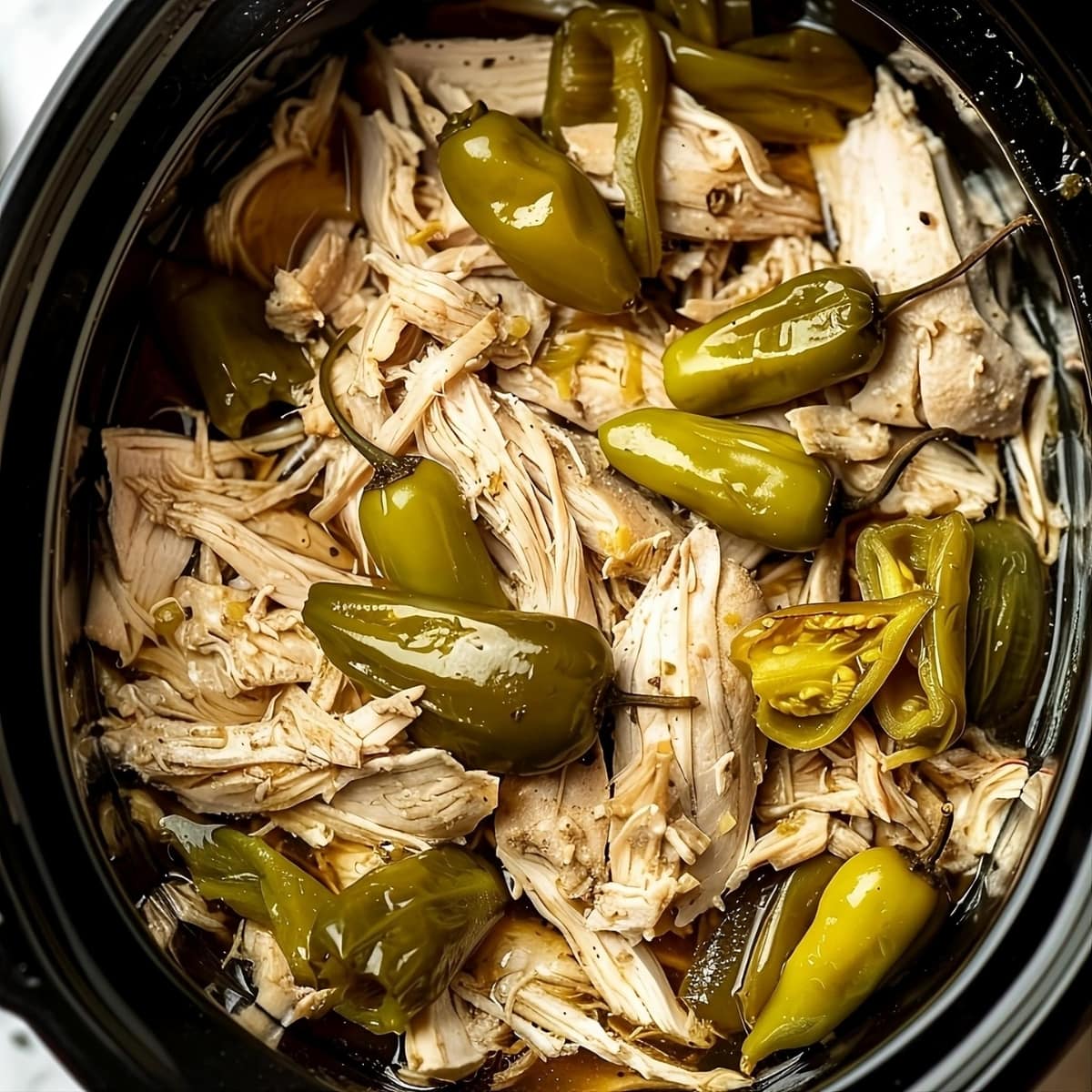 Crockpot Mississippi Chicken top view topped with peppers.