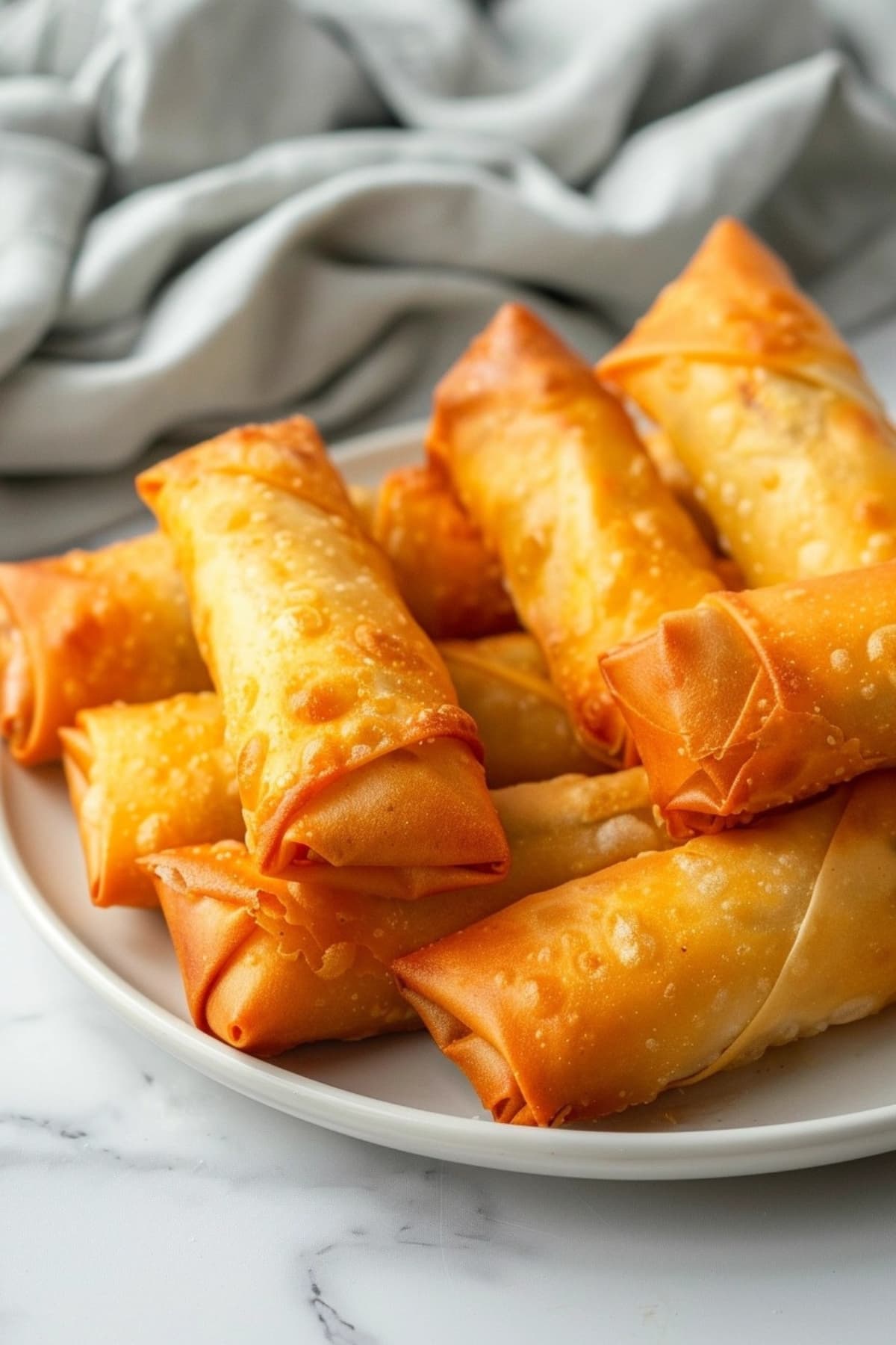 Air fried egg rolls in a white plate.