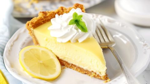 A delightful treat of sweet lemon icebox pie with graham crust in a plate