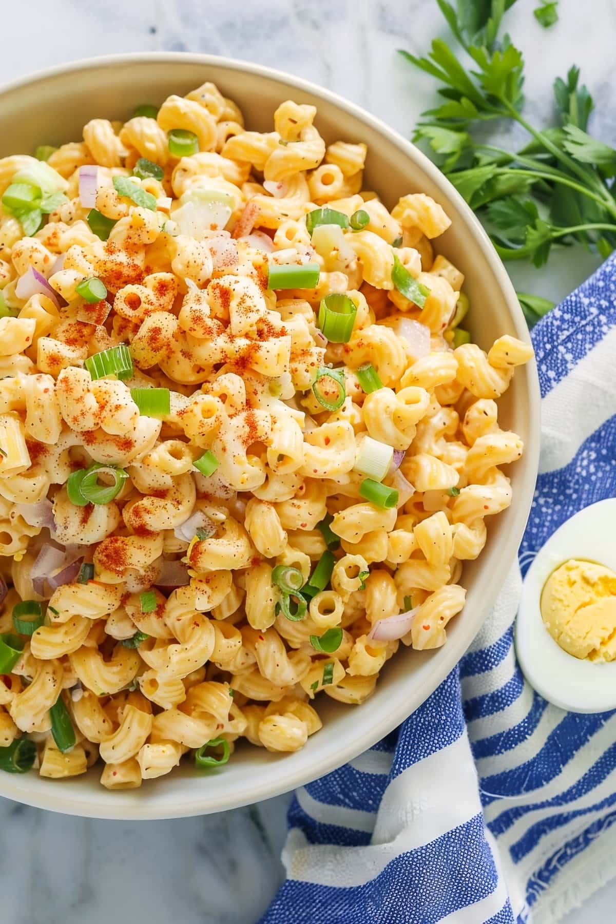 Homemade deviled egg pasta salad with paprika, celery and onions