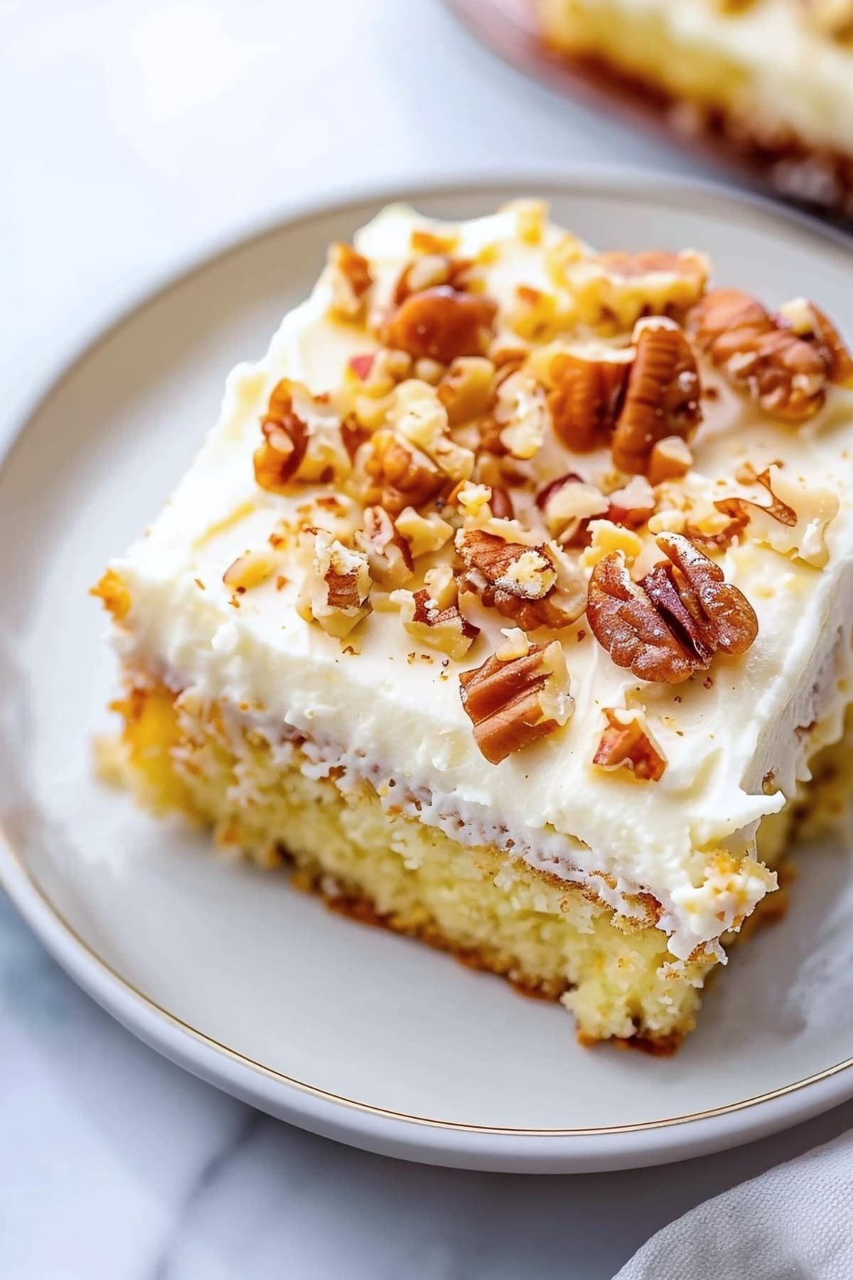 Pecan-topped Elvis Presley cake with cream cheese frosting in a white plate