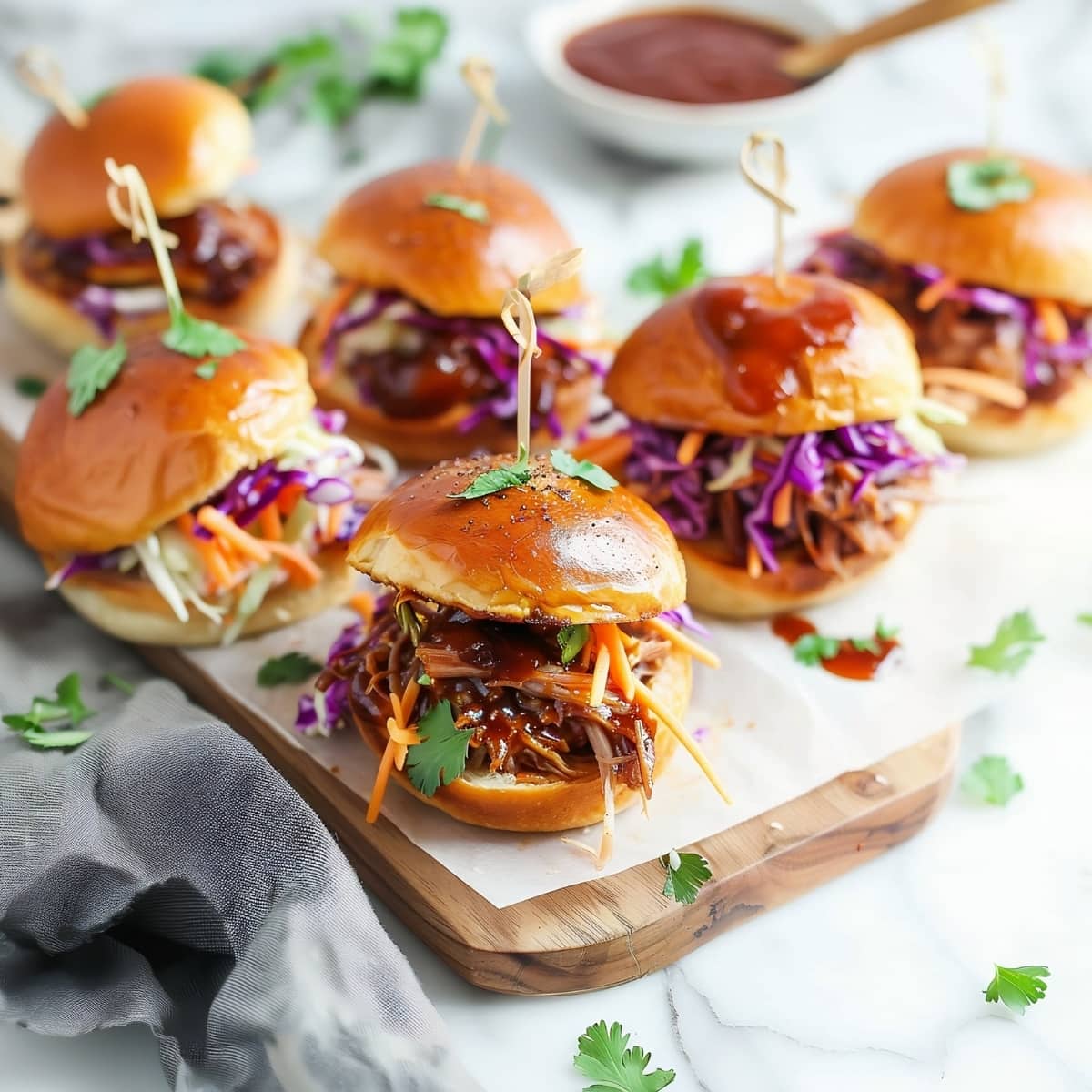 Delicious homemade pulled pork sliders in a wooden board