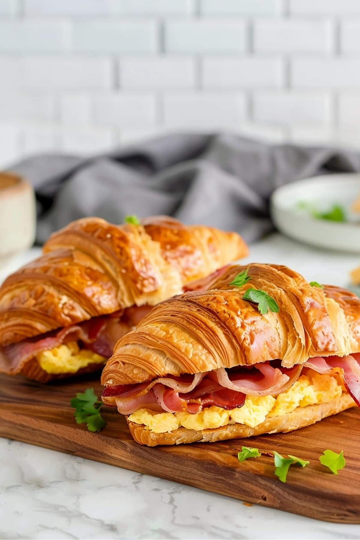 Croissant breakfast sandwich with scrambled eggs, bacon and cheese