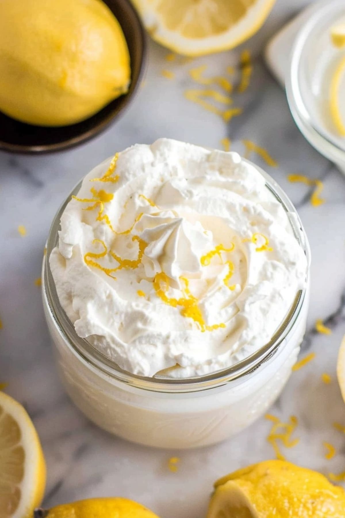Fluffy lemon whipped cream in a small jar.