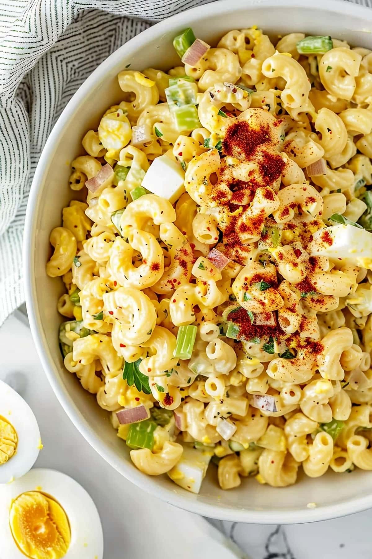 Creamy and tangy homemade deviled egg macaroni pasta salad with chopped egg whites and spices
