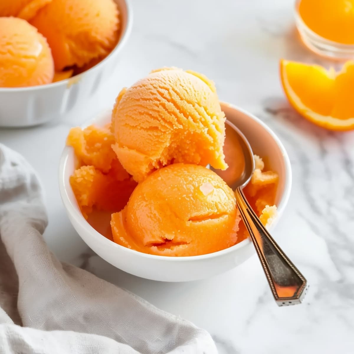 A bowl of homemade orange sorbet with a citrus twist