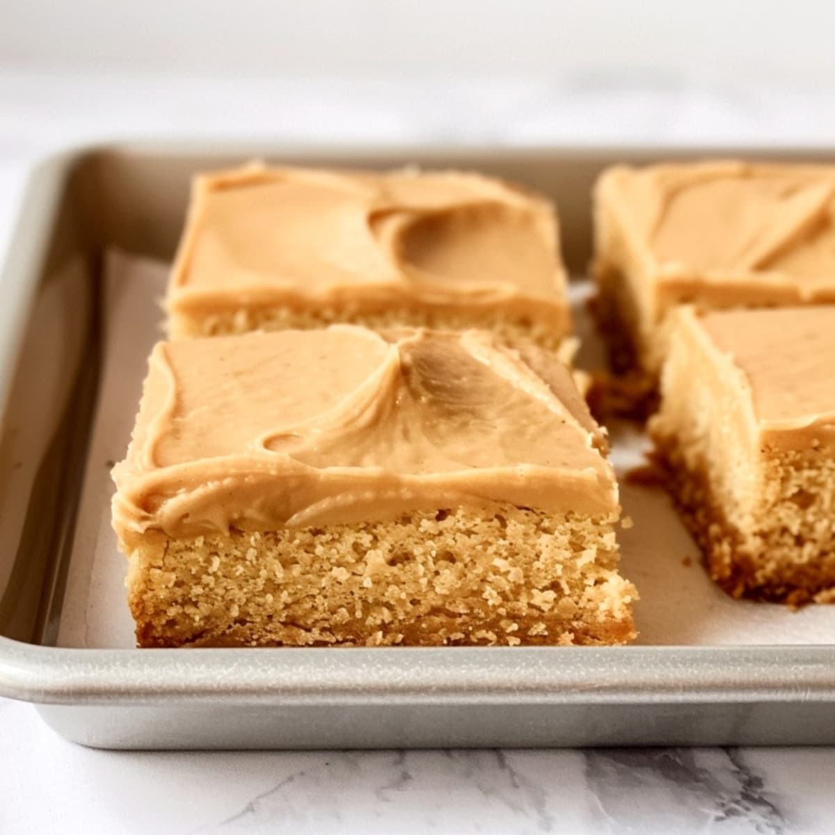 Peanut butter sheet cake topped with a smooth layer frosting