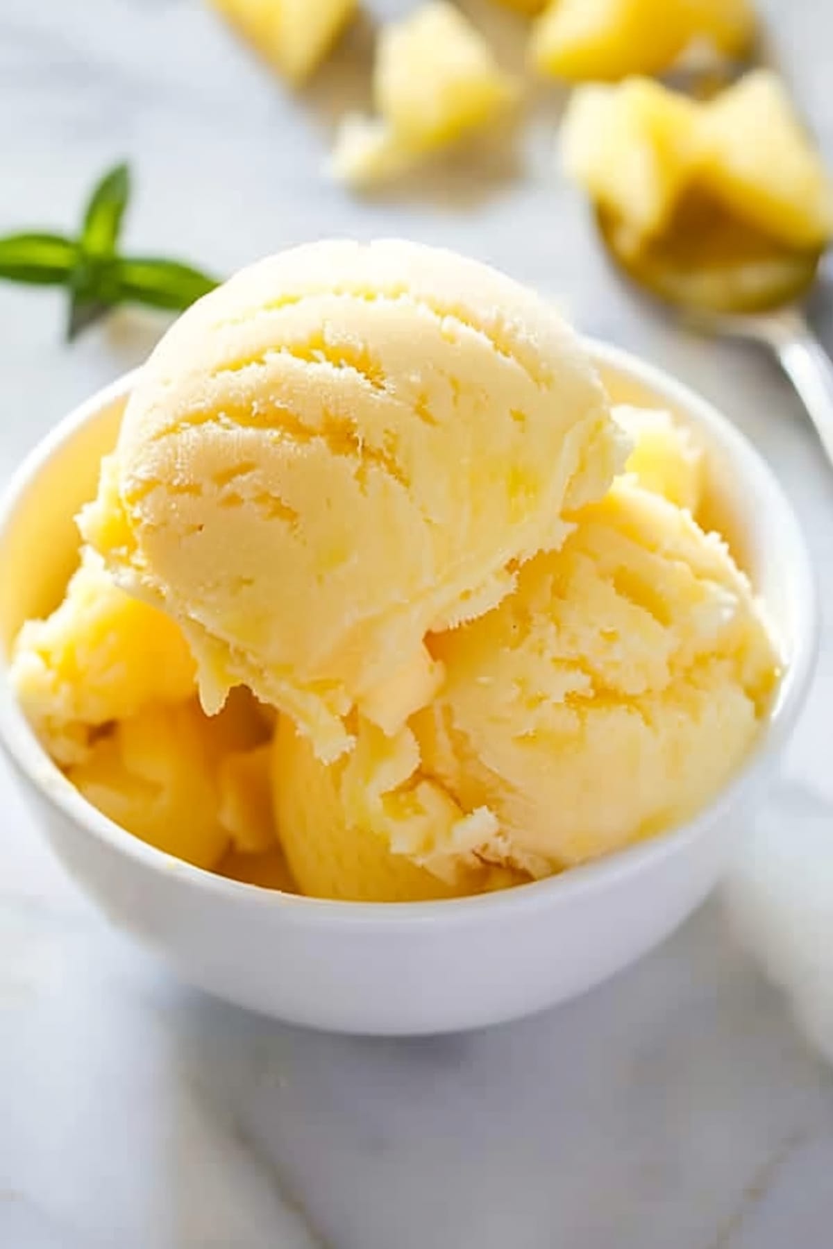 Pineapple sorbet ice cream in a bowl: a refreshing treat with a creamy texture and a tropical flavor