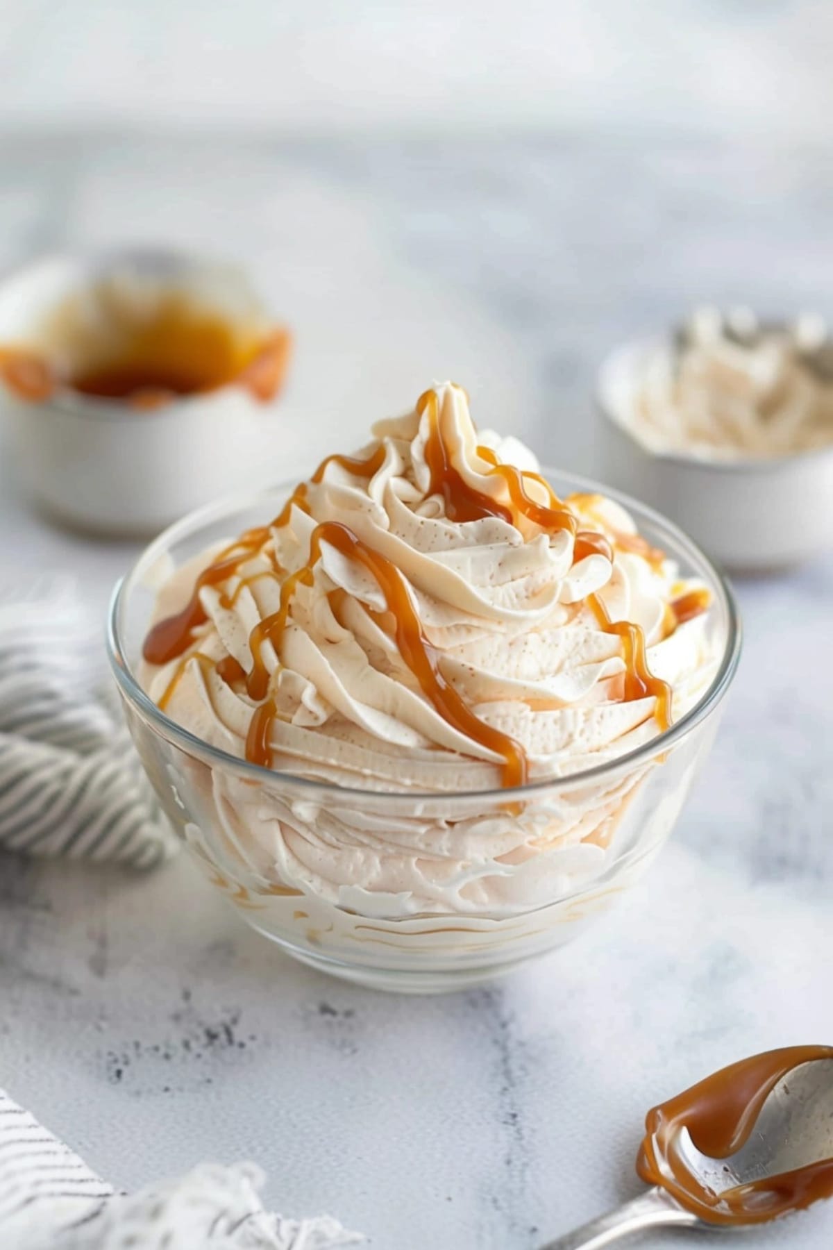 Whipped cream with salted caramel in a glass bowl.